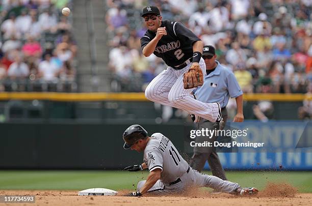 Shortstop Troy Tulowitzki of the Colorado Rockies turns a double play as he gets the force on Omar Vizquel of the Chicago White Sox at second on a...