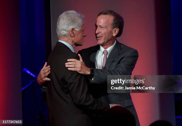 Former U.S. President Bill Clinton and Neil Bush attend The George H.W. Bush Points Of Light Awards Gala at Intrepid Sea-Air-Space Museum on...