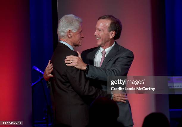 Former U.S. President Bill Clinton and Neil Bush attend The George H.W. Bush Points Of Light Awards Gala at Intrepid Sea-Air-Space Museum on...