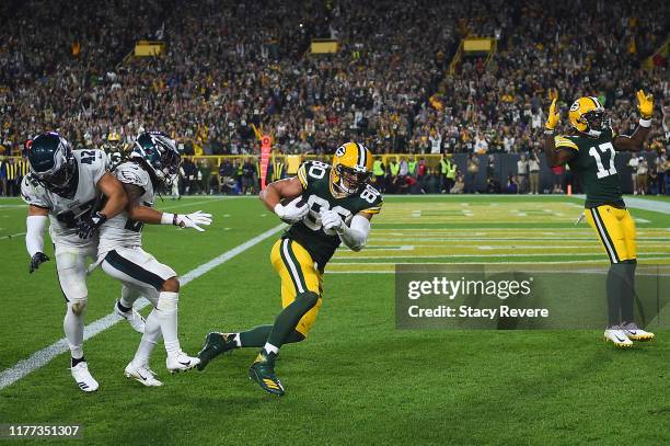 Jimmy Graham of the Green Bay Packers breaks a tackle by Andrew Sendejo and Avonte Maddox of the Philadelphia Eagles to score a touchdown during the...