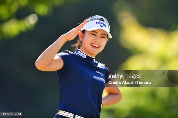 Yui Kawamoto of Japan poses for photographs after her tee shot on the 8th hole during the first round of the Miyagi TV Cup Dunlop Women's Open at...