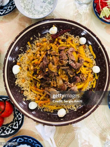 samarkand-style uzbek plov on a table - uzbekistan stock pictures, royalty-free photos & images