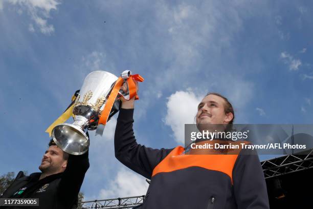 Trent Cotchin of the Tigers and Phil Davis of the Giants hold the Premiership cup aloft during the 2019 AFL Grand Final Parade on September 27, 2019...