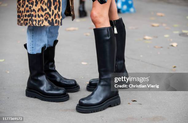 Linda Tol seen wearing denim jeans, black boots, coat with animal leopard print and Chloe Harrouche wearing black boots outside Paco Rabanne during...