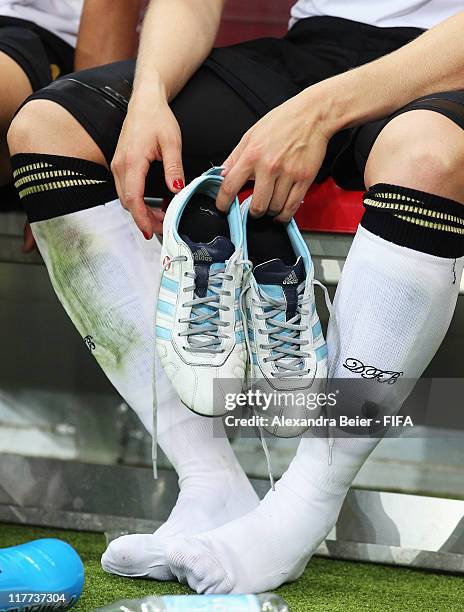 Kim Kulig of Germany holds her soccer shoes after her team won the FIFA Women's World Cup 2011 Group A match between Germany and Nigeria at the FIFA...