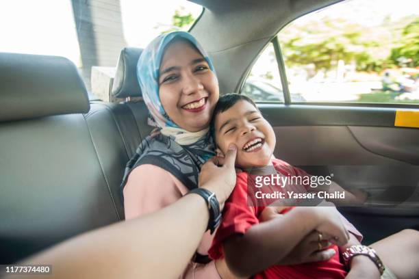 Mother and Son in a Taxi car