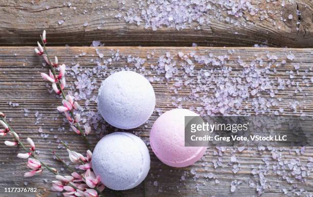 bath bombs and bath salt on wood - bath bomb stock pictures, royalty-free photos & images