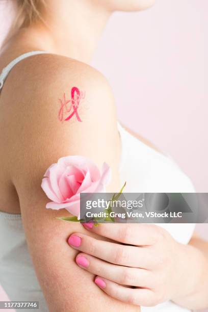 Teenage Girl With Breast Cancer Awareness Ribbon Tattoo On Arm High-Res  Stock Photo - Getty Images