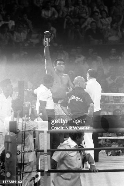 Heavyweight boxing champion Muhammad Ali raises his arms in victory as he defeats Joe Frazier by a technical knockout in the boxing match known as...