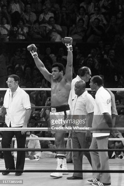 Heavyweight boxing champion Muhammad Ali raises his arms in victory as he defeats Joe Frazier by a technical knockout in the boxing match known as...