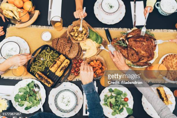 overhead view of table during christmas dinner - meal stock pictures, royalty-free photos & images