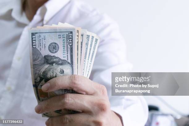 man holding dollar banknote.young businessman holding money.business and finances making and saving money concept. - cash contest stock pictures, royalty-free photos & images