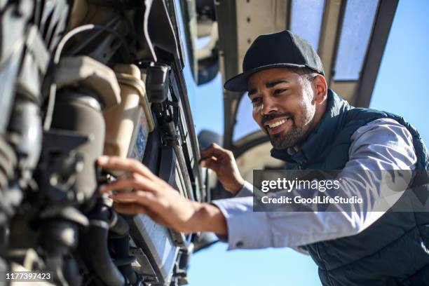 mechanic repairing a truck engine - truck repair stock pictures, royalty-free photos & images