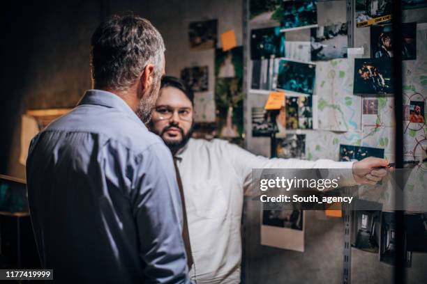 two detectives in office looking for clues - police chief stock pictures, royalty-free photos & images