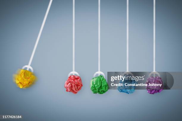 newton's cradle. colorful crumpled paper balls business concept. - legal proceeding stock-fotos und bilder