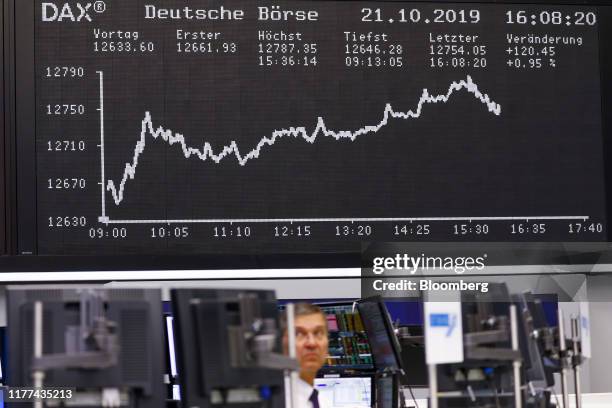 The DAX Index curve is displayed as a trader monitors financial data inside the Frankfurt Stock Exchange, operated by Deutsche Boerse AG, in...