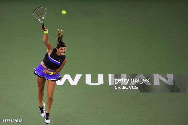 Aryna Sabalenka of Belarus serves in the semi-final match against Ashleigh Barty of Australia on Day six of 2019 Dongfeng Motor Wuhan Open at Optics...