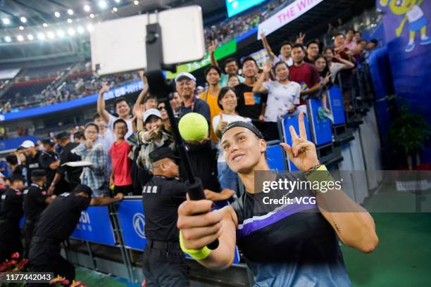 Aryna Sabalenka of Belarus takes a selfie with fans after winning the semi-final match against Ashleigh Barty of Australia on Day six of 2019...