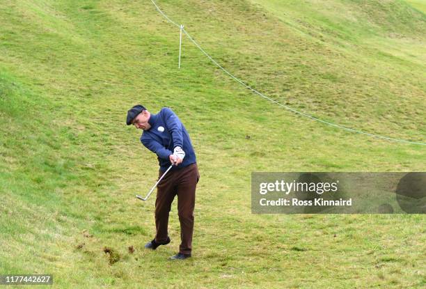 Former football player Vinnie Jones plays their second shot on the 10th hole during Day two of the Alfred Dunhill Links Championship at Kingsbarns...