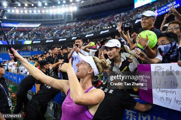 Alison Riske of the United States takes photos with fans afte the Ladies single semifinal against Petra Kvitova Day 6 of 2019 Dongfeng Motor Wuhan...