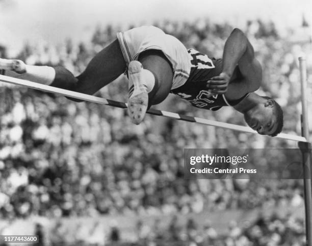 American high-jumper John Thomas clearing the qualifying height of two metres in the qualification round of the Men's High Jump event at the Olympic...