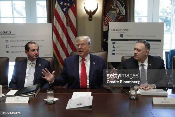 President Donald Trump, center, speaks while Alex Azar, secretary of Health and Human Services , left, and Mike Pompeo, U.S. Secretary of state,...