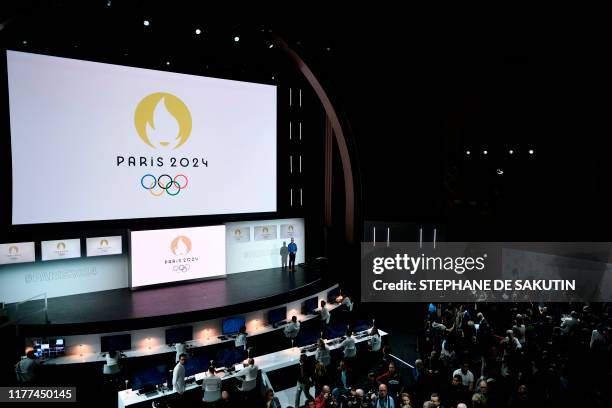 People attend a logo presentation ceremony for Paris 2024 Olympic Games at the Grand Rex cinema in Paris on October 21, 2019.