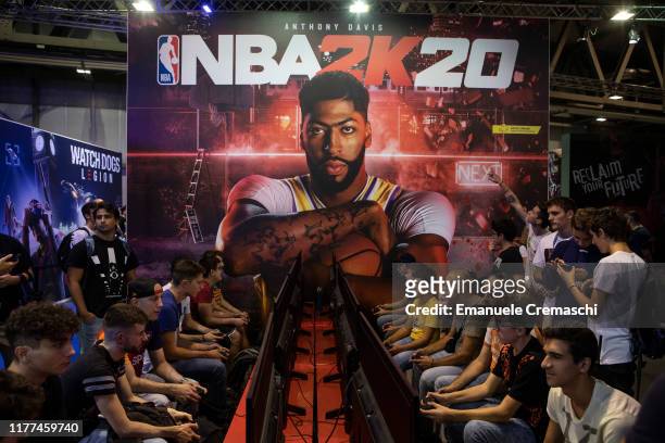 Fairgoers play NBA 2K20 at the PS4 PlayStation stand during the Milan Games Week 2019, on September 27, 2019 in Milan, Italy. The Milan Games Week is...