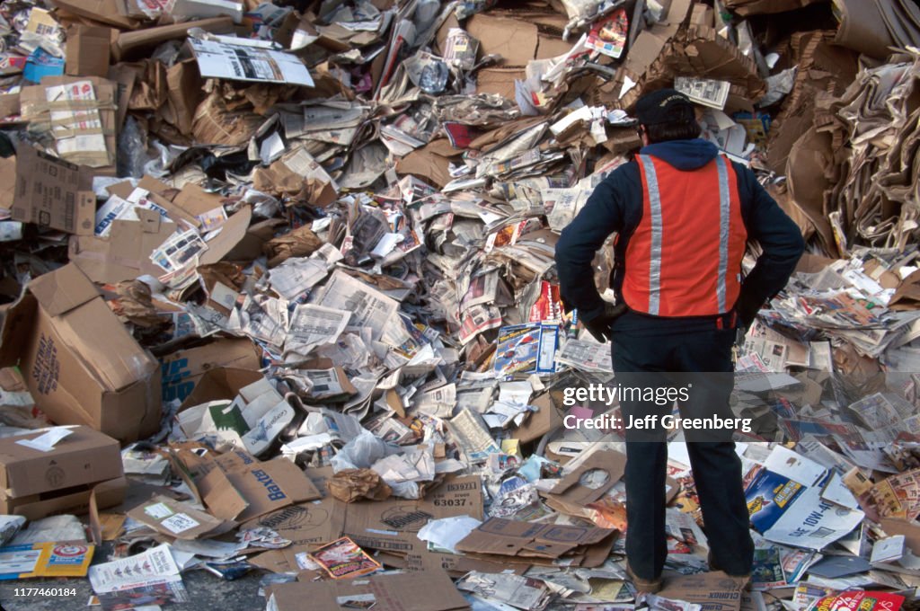 Newark, recycling center, worker sorting cardboard