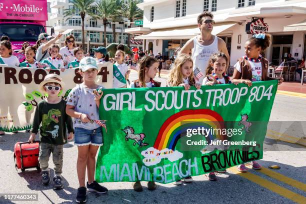 Miami Beach, Veterans Day Parade, Brownies Girl Scouts troop marching with banner.