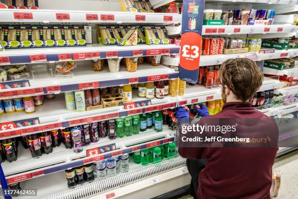 London, Sainsbury's supermarket, worker stocking refridgerated case.