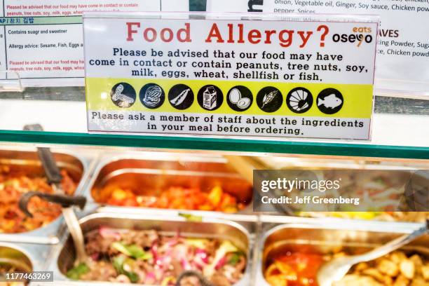 London, food allergy warning sign over buffet.