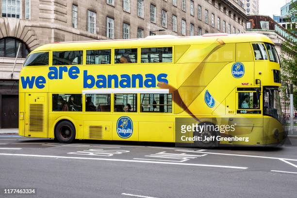 London, yellow double decker bus, Chiquita Bananas wrapped advertisement.