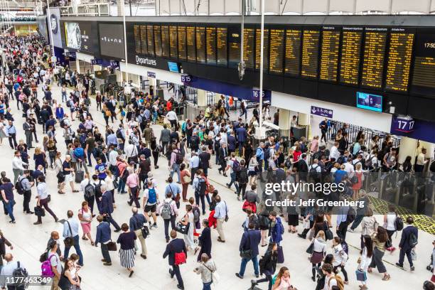London, Waterloo Station, crowded station with digital departure board.