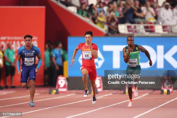 Christopher Belcher of the United States, Zhenye Xie of China and Akani Simbine of South Africa compete in the Men's 100 metres heats during day one...