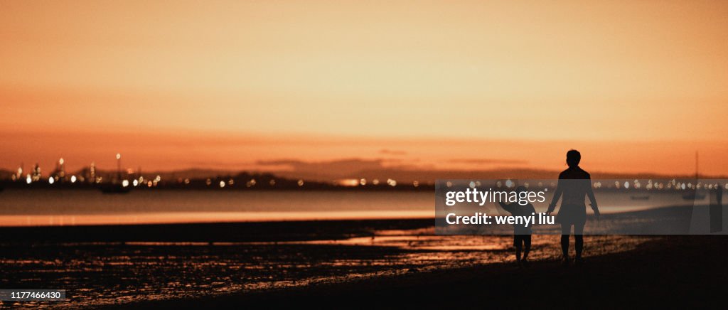 A Young Lady Together with a Child Was Walking in the Stunning Sunset at Wellington Point, Brisbane, Australia