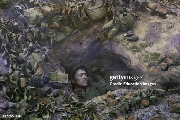 Two U.S. Infantrymen Share a Foxhole near Frontlines after the Allied Invasion of Normandy, Near Bayeux, Calvados, France, July 1944.