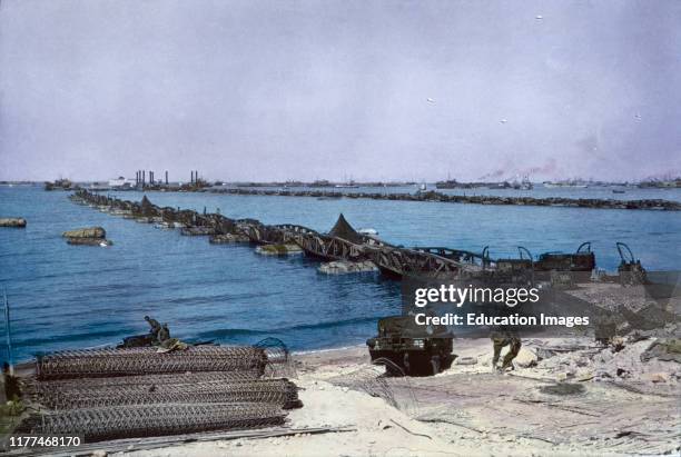 Military Vehicles crossing Pontoon Bridge to Omaha Beach from Temporary Mulberry Harbor A, Normandy, France, June 16, 1944.