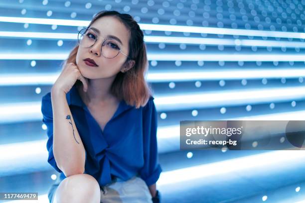 portrait of young woman at night - tattooed asian women stock pictures, royalty-free photos & images