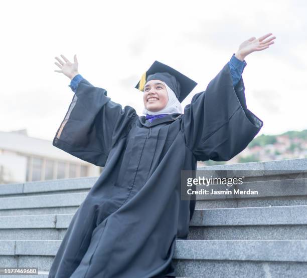 arab girl during graduation ceremony on stairs - beautiful arabian girls stock pictures, royalty-free photos & images