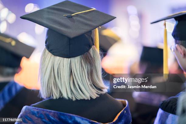 students during graduation ceremony - gown stock pictures, royalty-free photos & images