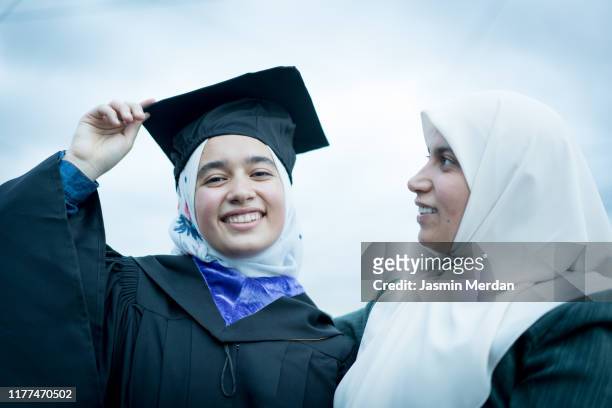 portrait of muslim arabic teen girl after graduation ceremony with mother - beautiful arabian girls stock pictures, royalty-free photos & images