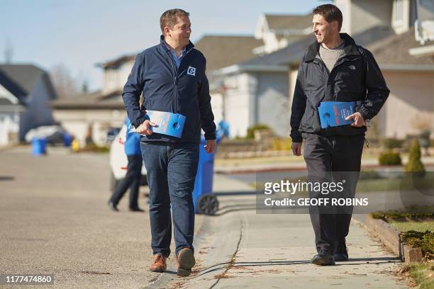 Conservative leader Andrew Scheer does some election day canvasing with local candidate Michael Kram in Regina, Saskatchewan on October 21, 2019. -...