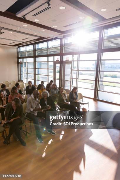 high angle view expo audience anticipating first speaker - diverse town hall meeting stock pictures, royalty-free photos & images