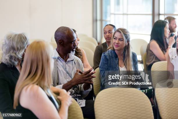 before expo begins, diverse attendees get to know each other - diverse town hall meeting stock pictures, royalty-free photos & images