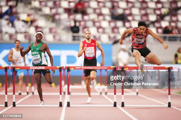Rilwan Alowonle of Nigeria, Kariem Hussein of Switzerland and Takatoshi Abe of Japan compete in the Men's 400 metres hurdles heats during day one of...