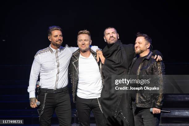 Keith Duffy, Ronan Keating, Shane Lynch and Mikey Graham of Boyzone perform on stage during "The Final Five tour" at the London Palladium on October...