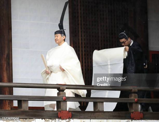 Japan's Emperor Naruhito walks to Kashikodokoro sanctuary to report the proclamation of his ascension to the throne to sun goddess in the ancient...