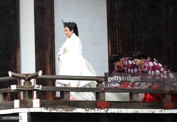 Japan's Empress Masako walks to Kashikodokoro sanctuary where Emperor Naruhito reports the proclamation of his ascension to the throne to sun goddess...