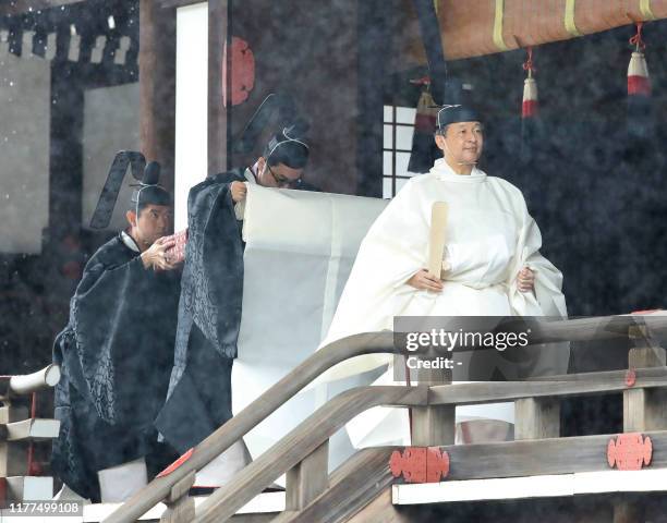 Japan's Emperor Naruhito leaves Kashikodokoro sanctuary after reporting the proclamation of his ascension to the throne to sun goddess in the ancient...